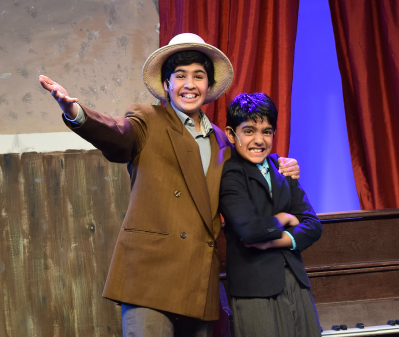 Two children in suits, from the musical "Singin' In The Rain Jr".