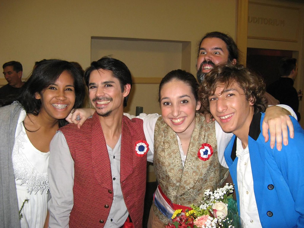 Five smiling actors from the musical "Les Miserables".